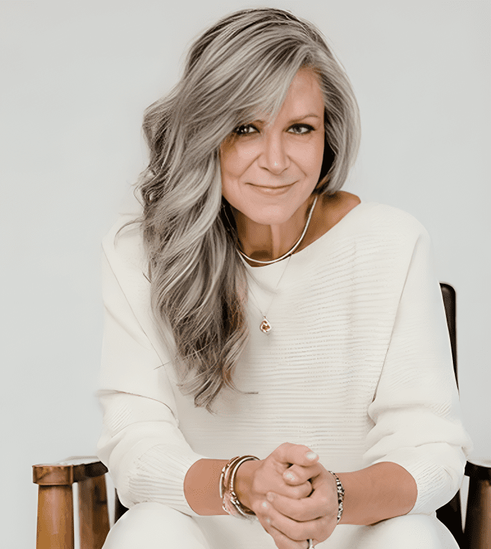 Woman with long gray hair smiling